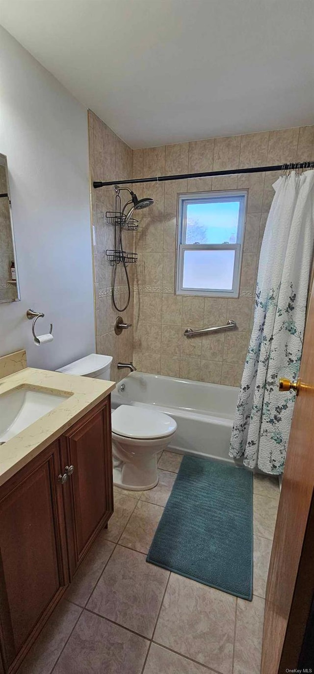 full bathroom featuring toilet, shower / tub combo with curtain, vanity, and tile patterned flooring