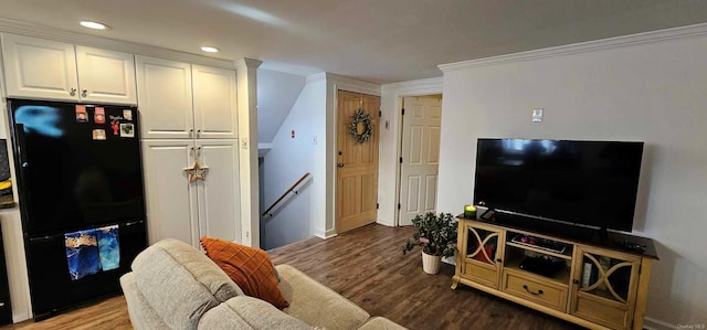 living room with wood-type flooring and crown molding