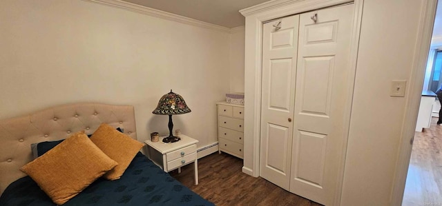 unfurnished bedroom featuring dark hardwood / wood-style floors, ornamental molding, a baseboard radiator, and a closet