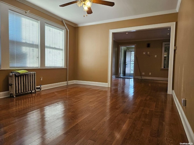 spare room featuring ornamental molding, radiator, and dark wood-type flooring