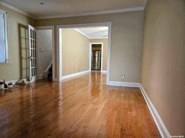 unfurnished room featuring ornamental molding and light hardwood / wood-style flooring