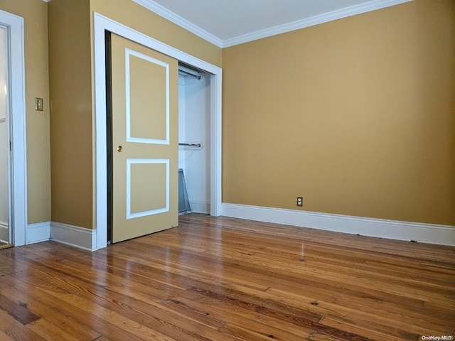 unfurnished room featuring hardwood / wood-style floors and ornamental molding