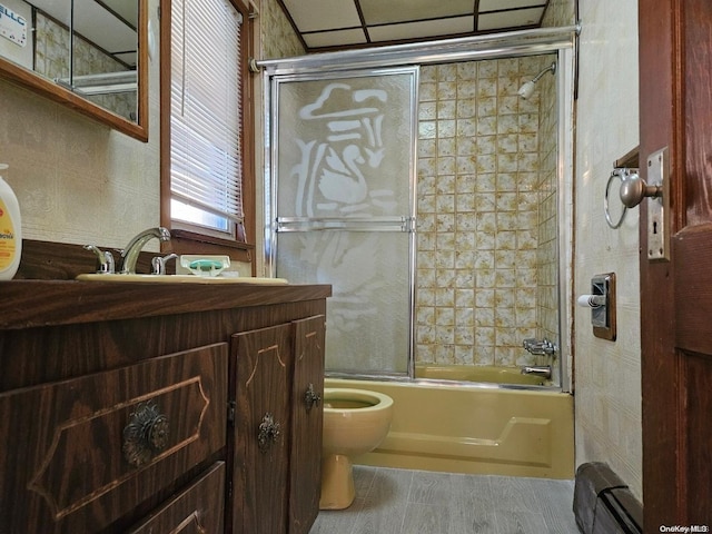 full bathroom featuring shower / bath combination with glass door, vanity, and toilet