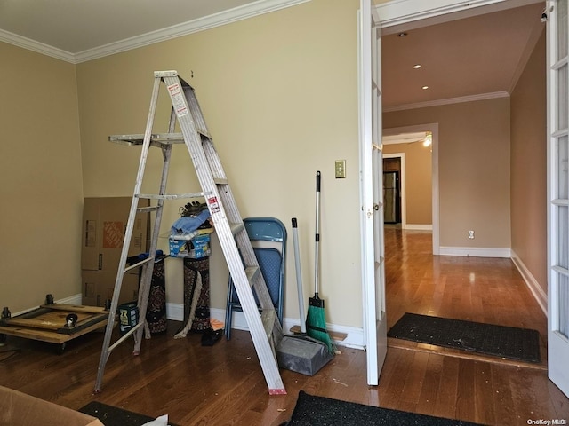 workout room featuring hardwood / wood-style flooring and ornamental molding