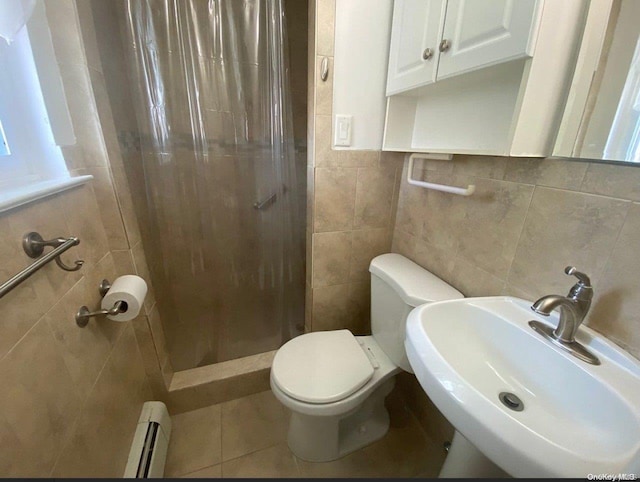 bathroom featuring a shower with shower curtain, a baseboard heating unit, sink, tile walls, and toilet