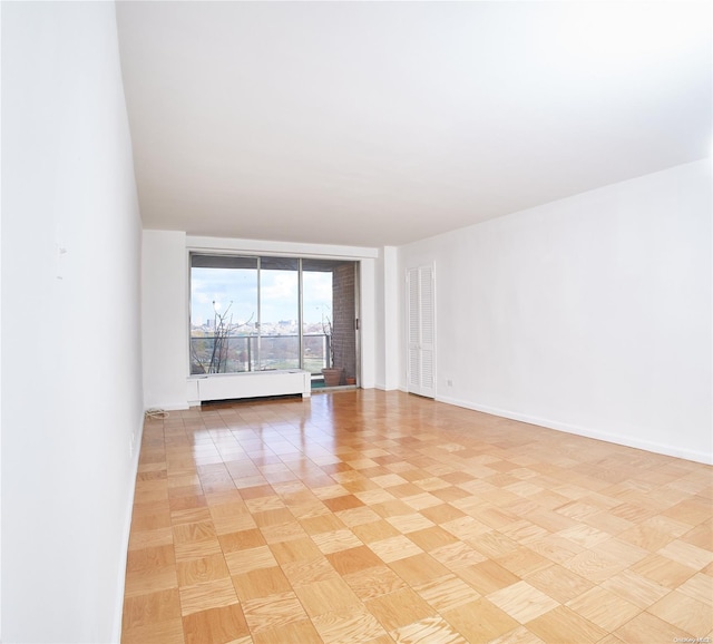 unfurnished room with light parquet floors