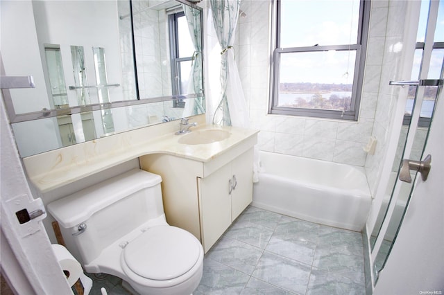 full bathroom featuring plenty of natural light, toilet, vanity, and tiled shower / bath combo