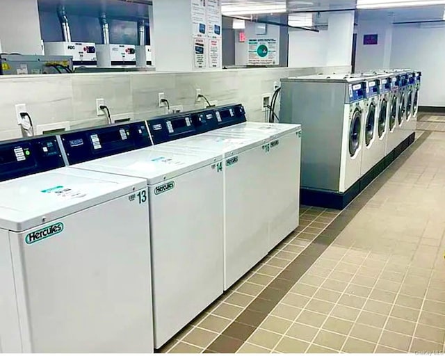 laundry area with tile patterned floors and separate washer and dryer