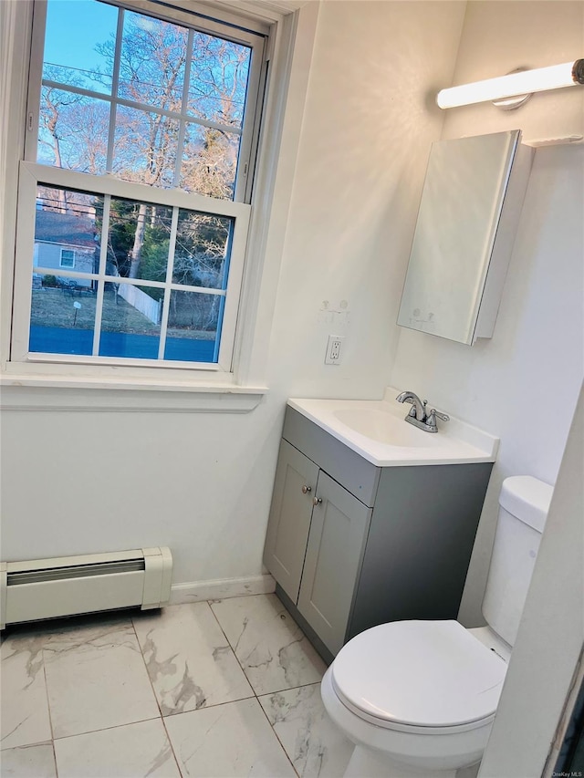 bathroom featuring baseboard heating, vanity, and toilet