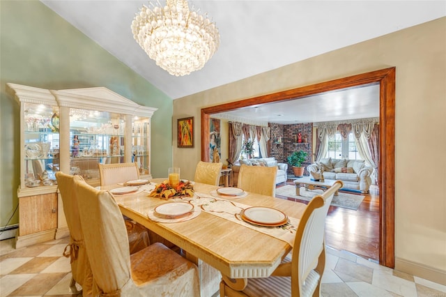 dining room featuring an inviting chandelier and lofted ceiling