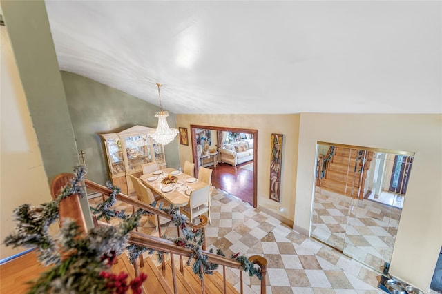 dining area featuring lofted ceiling and an inviting chandelier