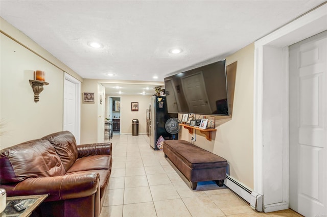 living room featuring light tile patterned flooring and a baseboard heating unit