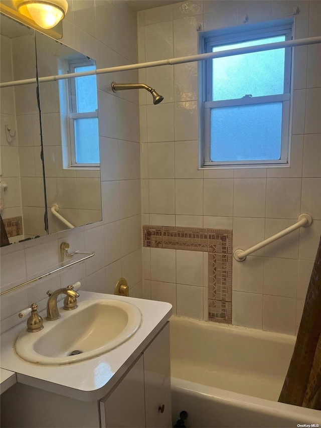 bathroom featuring shower / tub combo, vanity, and tile walls