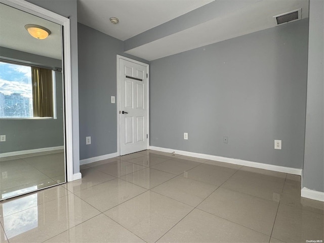 spare room featuring tile patterned flooring