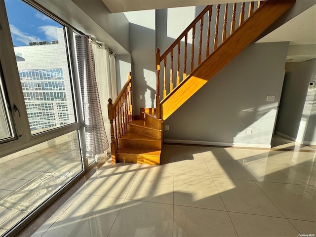 stairway featuring tile patterned flooring