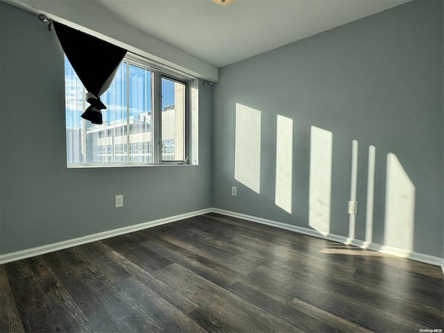 spare room with dark hardwood / wood-style floors