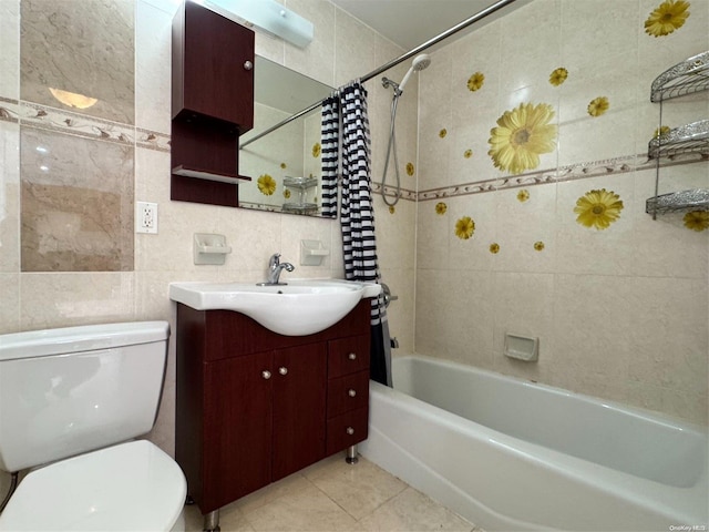 full bathroom with shower / tub combo, vanity, tile walls, tile patterned flooring, and toilet