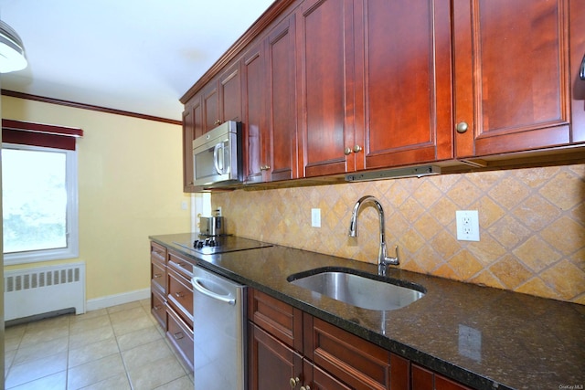 60 Tanglewood Dr, Smithtown, NY 11787 - kitchen with radiator, a sink, dark brown cabinets, stainless steel appliances, and baseboards
