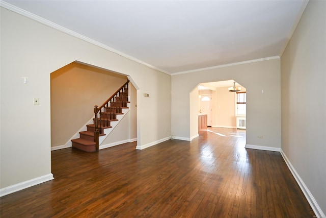 spare room with ornamental molding and dark hardwood / wood-style flooring