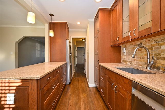 kitchen featuring appliances with stainless steel finishes, hanging light fixtures, light stone counters, and sink