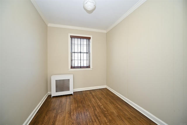 unfurnished room featuring dark wood-type flooring, radiator heating unit, and crown molding