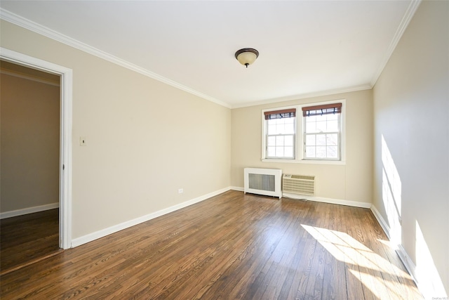 empty room featuring ornamental molding, dark hardwood / wood-style flooring, and radiator