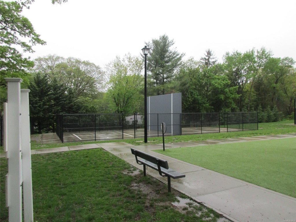 view of community with a tennis court