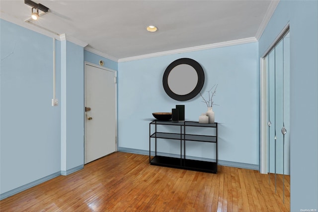 foyer featuring light hardwood / wood-style flooring and crown molding