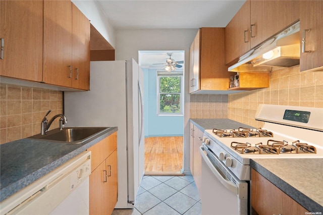 kitchen featuring white appliances, backsplash, sink, ceiling fan, and light tile patterned flooring