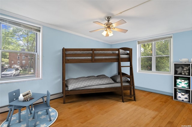 bedroom featuring ceiling fan, crown molding, and light hardwood / wood-style flooring