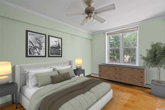 bedroom with ceiling fan, crown molding, and light hardwood / wood-style floors