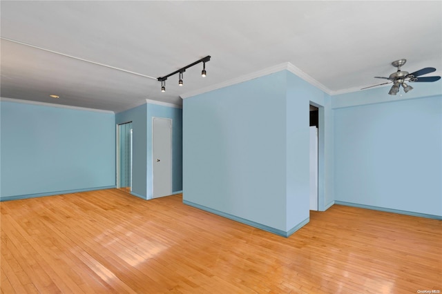 unfurnished room with ceiling fan, rail lighting, light hardwood / wood-style floors, and ornamental molding