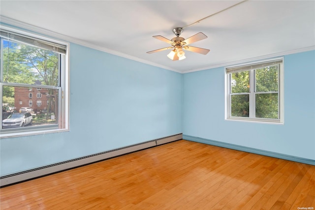 empty room featuring ceiling fan, light wood-type flooring, baseboard heating, and ornamental molding