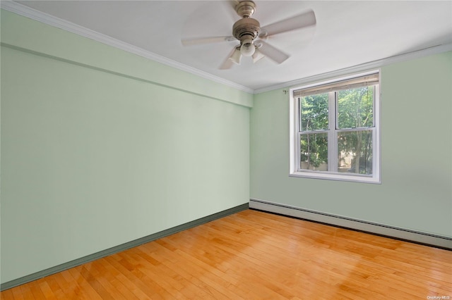 empty room with hardwood / wood-style floors, ceiling fan, crown molding, and baseboard heating