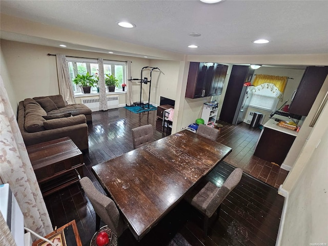 dining room with dark wood-type flooring and radiator