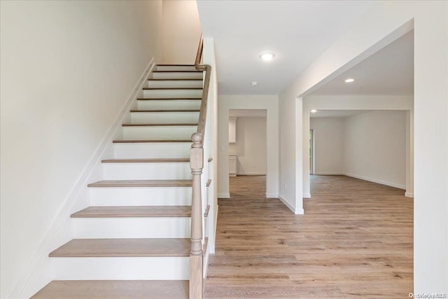 stairs with hardwood / wood-style flooring