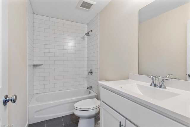 full bathroom featuring tile patterned floors, vanity, toilet, and tiled shower / bath