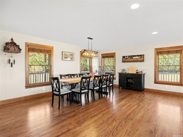 dining room with recessed lighting, baseboards, and wood finished floors