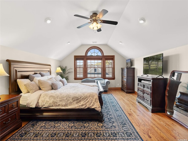 bedroom featuring light wood-type flooring, vaulted ceiling, a ceiling fan, and visible vents