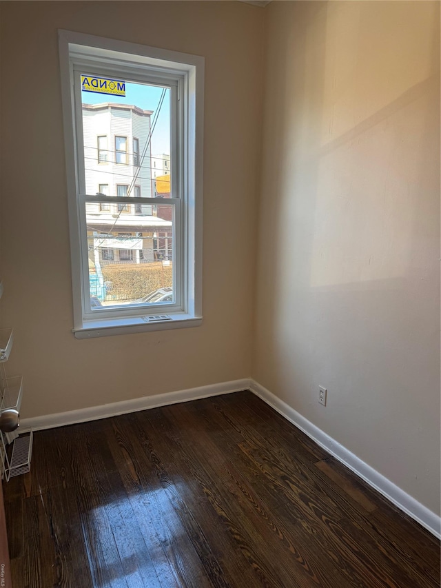 776 Hewitt, Bronx, NY 10455 - unfurnished room featuring visible vents, baseboards, and dark wood-style flooring
