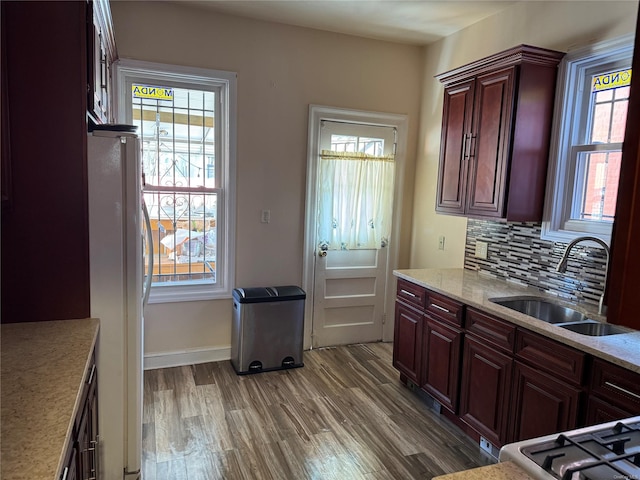 776 Hewitt, Bronx, NY 10455 - kitchen with tasteful backsplash, a sink, freestanding refrigerator, wood finished floors, and reddish brown cabinets
