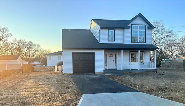 view of front of house with covered porch and a garage