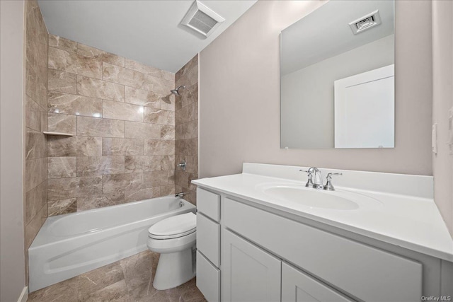 full bathroom with tiled shower / bath combo, vanity, and toilet