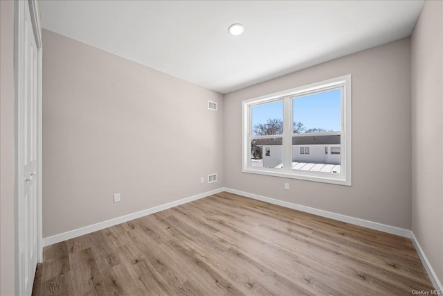 unfurnished room with light wood-type flooring