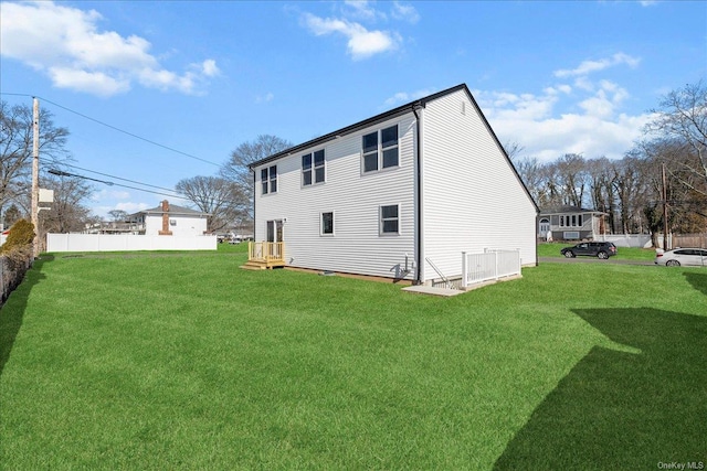 rear view of property featuring a yard