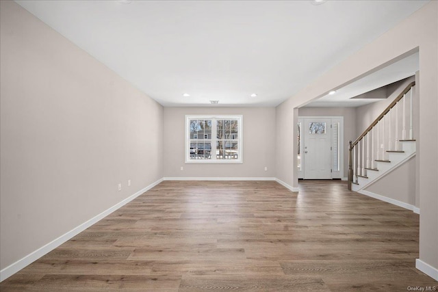 entryway with hardwood / wood-style floors