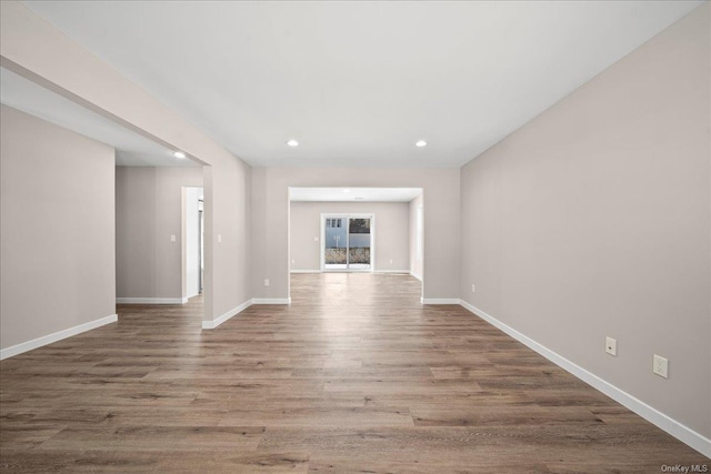 unfurnished living room with wood-type flooring