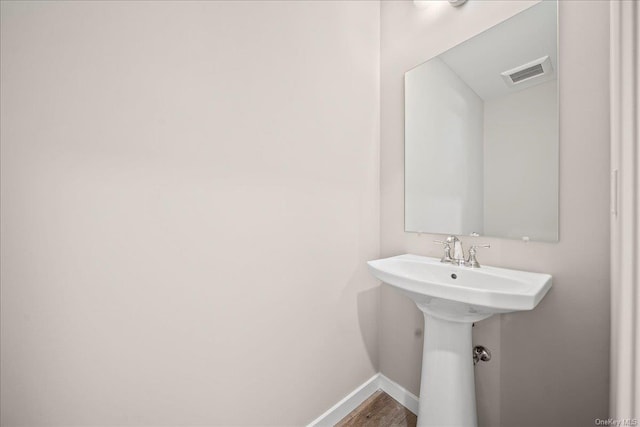 bathroom with hardwood / wood-style flooring