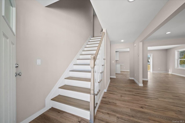 staircase featuring wood-type flooring