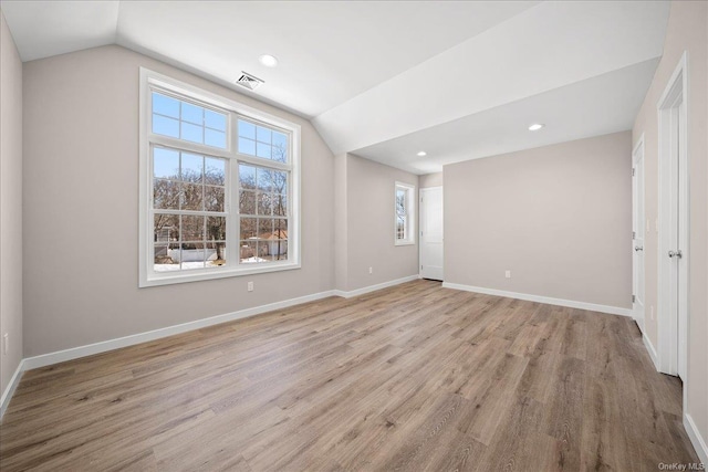 interior space featuring lofted ceiling and light wood-type flooring